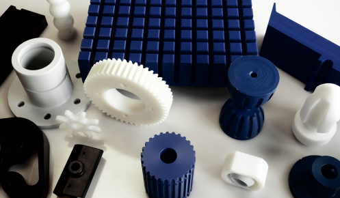 A selection of blue, white and grey engineering plastics that have been precisely finished by a CNC machine.
