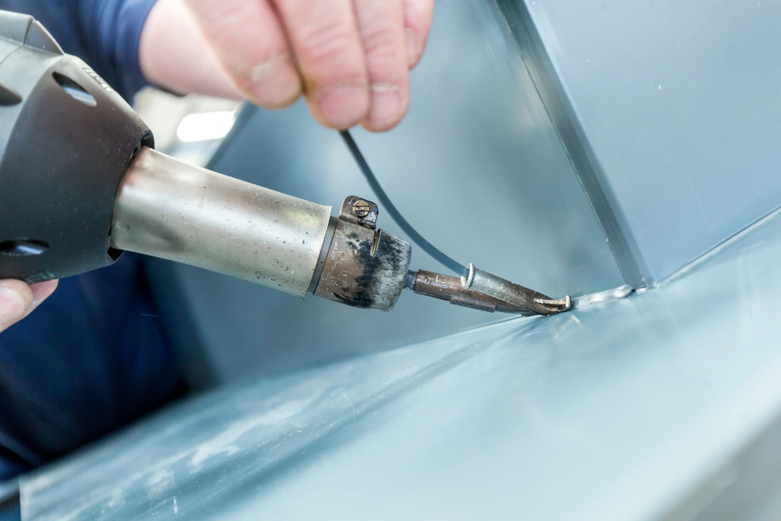 Fabrication image of a gun welding two pieces of fabricated plastics together