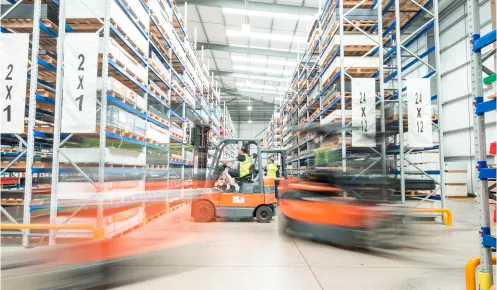 An image of forklift trucks moving around the warehouse of Oadby Plastics