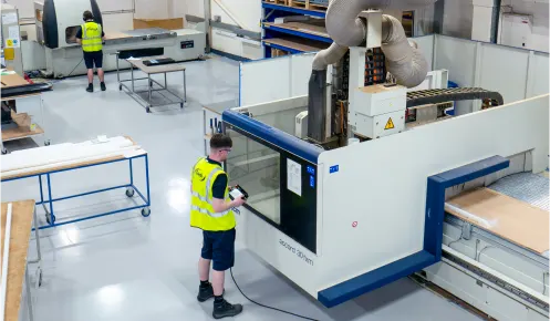 Operators at a CNC machines at Oadby Plastics production hall