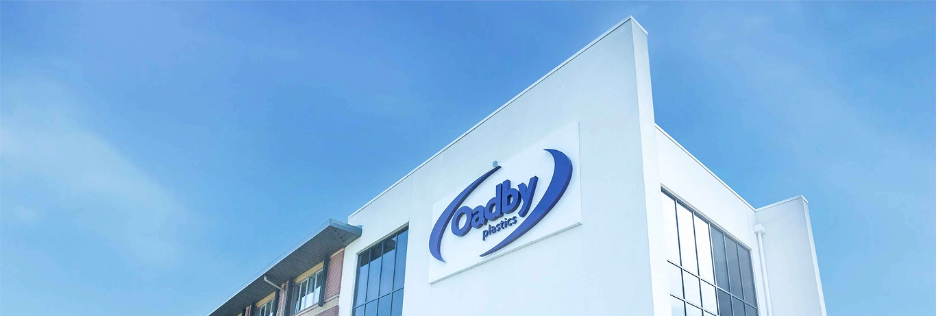 Oadby Plastics head office with blue skies and big logo