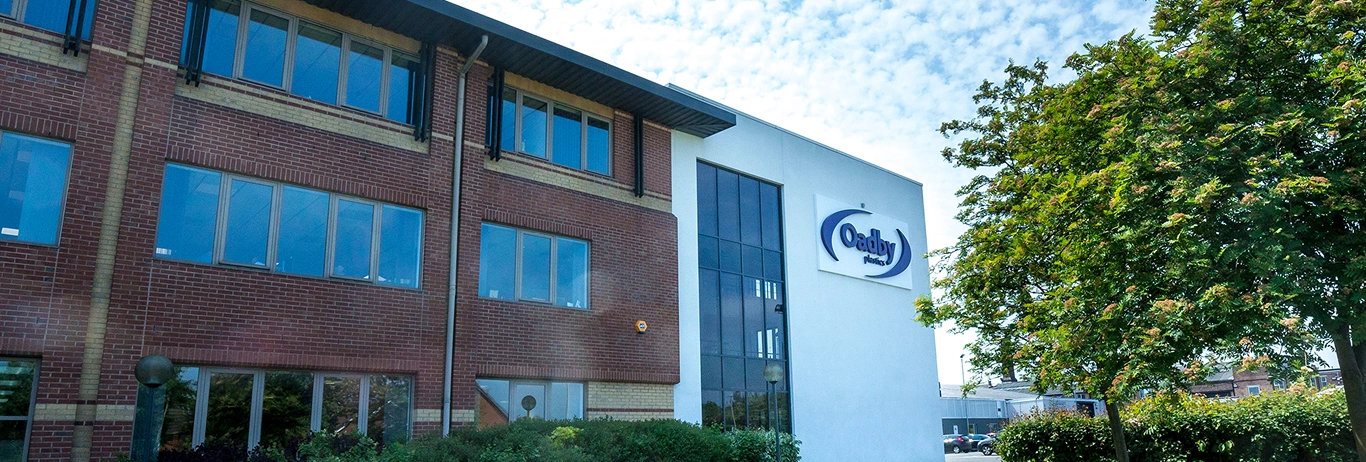 Oadby Plastics head office at Leicester with green trees and solar panels on the building