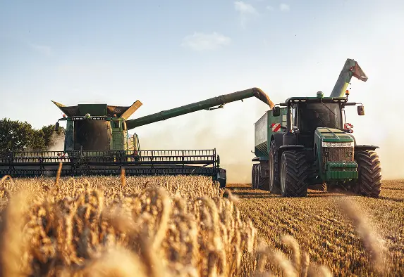 Plastic used in the agriculture industry on a working farm with tractor and combine harvester