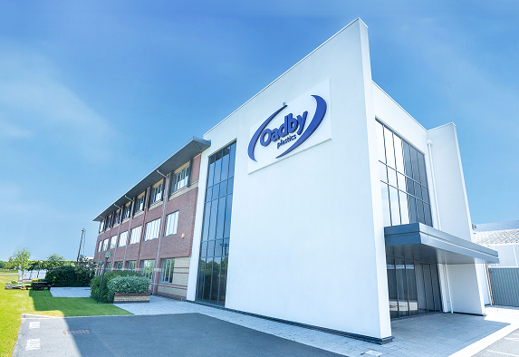 Oadby Plastics head office with blue skies and green grass