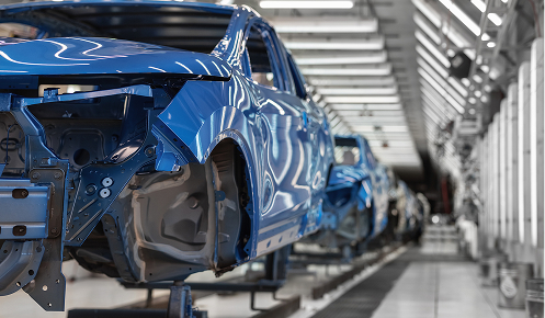 Plastics for the automotive industry and a conveyor belt of cars in production