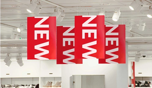 Sales and promotional banners made from printed plastic hanging from the ceiling in a retail store