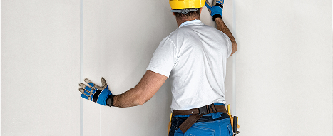 A man fitting internal hygienic cladding sheets