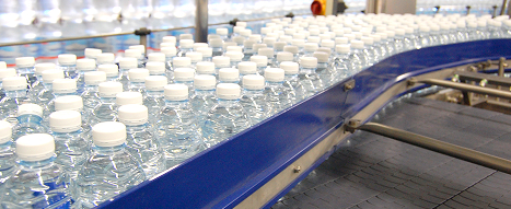 Conveyor belt with bottles for the beverage industry showcasing plastic guard rails