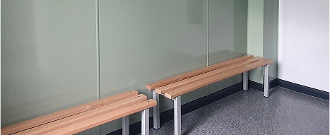 Internal hygienic cladding sage green in a locker room with a bench