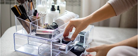 An acrylic plastic makeup stand with compartments and fabricated elements