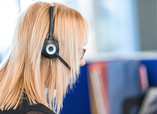 Experienced team member with a headset speaking to customers at Oadby Plastics