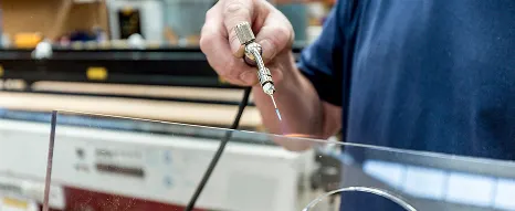 Flame polishing some clear plastic close up by an experienced team member at Oadby Plastics