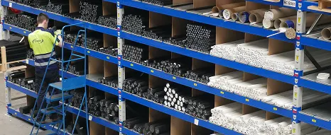 An Oadby Plastics warehouse operative picking plastic rods from an extensive range of stock with various sizes available