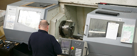 An operator at a CNC turning machine