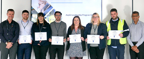 Employees at Oadby Plastics holding certificates as they have completed internal training