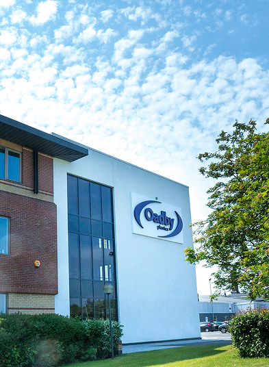 Portrait image of Oadby Plastics head office at Leicester with green trees and solar panels on the building