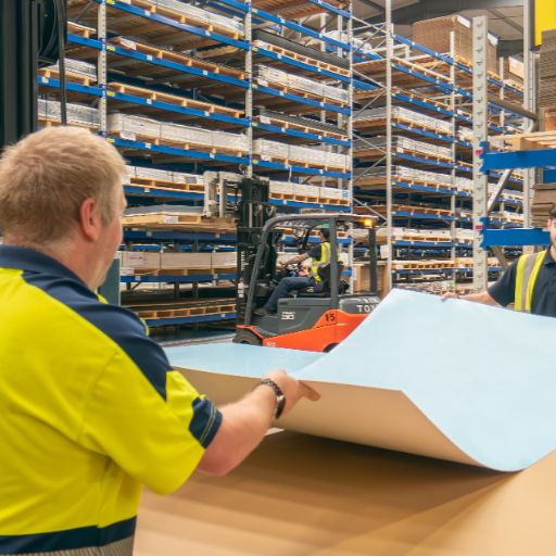Team member handling sheet of plastic at Oadby Plastics